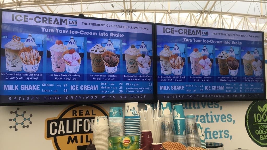 Live Ice-Cream Lab menu boards on a Volume-IT digital signage pair in a retail counter.